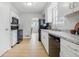 Modern kitchen featuring white cabinets, updated appliances, and sleek countertops at 450 N Fenton Ave, Indianapolis, IN 46219