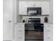 Well-equipped kitchen featuring black appliances, white cabinets, and modern countertops at 450 N Fenton Ave, Indianapolis, IN 46219
