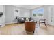 Cozy living room showcasing a sofa, chairs, and a view of the outdoors through large windows at 450 N Fenton Ave, Indianapolis, IN 46219