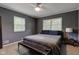 Cozy bedroom featuring a ceiling fan, large windows and comfortable dark gray accents at 4853 E 65Th St, Indianapolis, IN 46220