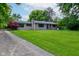 Attractive home exterior with a lush front yard and stone details at 4853 E 65Th St, Indianapolis, IN 46220