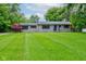 Charming stone home with a well-maintained lawn and mature trees at 4853 E 65Th St, Indianapolis, IN 46220