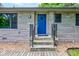 Inviting front entrance with a stylish blue door and stone accents at 4853 E 65Th St, Indianapolis, IN 46220