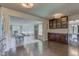 Bright and open kitchen with a view into a sunlit room, dark wood cabinets, and stainless steel appliances at 4853 E 65Th St, Indianapolis, IN 46220