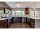 Well-equipped kitchen with stainless steel appliances, dark wood cabinetry, and ample countertop space for cooking at 4853 E 65Th St, Indianapolis, IN 46220