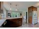 A kitchen island with white countertop and dark wood cabinets, complemented by pendant lighting above at 4853 E 65Th St, Indianapolis, IN 46220