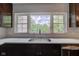 Close-up of the kitchen sink with a window overlooking a lush green yard, providing a bright and airy feel at 4853 E 65Th St, Indianapolis, IN 46220