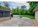 A large concrete patio offers outdoor living space, complete with a fire pit and wood storage near the house at 4853 E 65Th St, Indianapolis, IN 46220