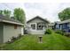 Charming backyard featuring a deck, lush lawn, and a bird bath, perfect for outdoor relaxation at 5133 E Michigan St, Indianapolis, IN 46219