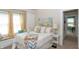 Cozy bedroom with a large window, neutral walls, and a comfortable bed with stylish linens at 5133 E Michigan St, Indianapolis, IN 46219
