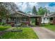 Charming craftsman home featuring a brick facade, covered porch, and well-manicured lawn at 5133 E Michigan St, Indianapolis, IN 46219