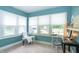 Sunlit office space with large windows, a cozy chair, and a functional desk setup, perfect for productivity at 5133 E Michigan St, Indianapolis, IN 46219