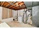 Unfinished basement with water heater, washer, dryer, and exposed ceiling beams at 5153 Brendonshire Ct, Indianapolis, IN 46226