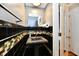 Stylish half-bathroom with black tile and sleek fixtures at 5153 Brendonshire Ct, Indianapolis, IN 46226