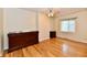 Well-lit bedroom features hardwood floors, a dresser, and a window with natural light at 5153 Brendonshire Ct, Indianapolis, IN 46226