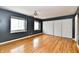 Bedroom with hardwood floors, two windows, and closet with sliding doors at 5153 Brendonshire Ct, Indianapolis, IN 46226