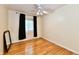 Bedroom features hardwood floors, natural light, and black curtains for added privacy at 5153 Brendonshire Ct, Indianapolis, IN 46226