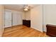 Bright bedroom with hardwood floors, dresser, and closet, bathed in natural light at 5153 Brendonshire Ct, Indianapolis, IN 46226