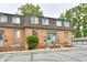 Charming brick two-story townhome with landscaped yard and a welcoming blue front door at 5153 Brendonshire Ct, Indianapolis, IN 46226