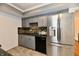 Modern kitchen with stainless steel appliances, sleek grey cabinets and tiled backsplash at 5153 Brendonshire Ct, Indianapolis, IN 46226