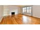 Living room featuring hardwood floors, fireplace with marble surround and built-in shelving at 5153 Brendonshire Ct, Indianapolis, IN 46226