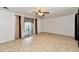 Bright living room features neutral flooring, a ceiling fan, and a sliding glass door for natural light at 5153 Brendonshire Ct, Indianapolis, IN 46226