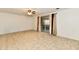 Bright living room features neutral flooring, a ceiling fan, and a sliding glass door for natural light at 5153 Brendonshire Ct, Indianapolis, IN 46226