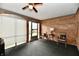 Charming sunroom features brick walls, carpet, and large windows offering a relaxing atmosphere at 5153 Brendonshire Ct, Indianapolis, IN 46226