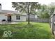 Spacious backyard with mature trees, patio area, and privacy fence at 5216 Lakeside Manor Blvd, Indianapolis, IN 46254