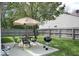 A backyard featuring a patio with dining set, grill, and a privacy fence at 5216 Lakeside Manor Blvd, Indianapolis, IN 46254