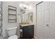 Well-lit bathroom featuring granite countertop, shelving, and modern fixtures at 5216 Lakeside Manor Blvd, Indianapolis, IN 46254