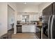 Bright kitchen boasts stainless steel appliances, white cabinetry, and an open layout at 5216 Lakeside Manor Blvd, Indianapolis, IN 46254
