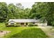 Charming ranch-style home with a well-manicured front yard and a welcoming red door at 5975 S 800 E, Zionsville, IN 46077