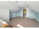 Finished attic space featuring an open layout, light blue walls and painted floor at 621 N Livingston Ave, Indianapolis, IN 46222