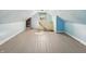 Finished attic features light blue walls, painted floors, and natural light at 621 N Livingston Ave, Indianapolis, IN 46222