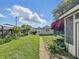Landscaped backyard featuring a grassy yard, a garden, a path, and mature trees at 621 N Livingston Ave, Indianapolis, IN 46222