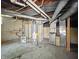 Basement view showcasing the water heater, exposed pipes, and HVAC system at 621 N Livingston Ave, Indianapolis, IN 46222