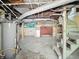 Basement view showcasing the water heater, storage, exposed pipes, and stairs at 621 N Livingston Ave, Indianapolis, IN 46222