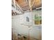 Basement view showcasing the breaker box, exposed pipes, and a small window at 621 N Livingston Ave, Indianapolis, IN 46222