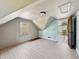 Attic bedroom featuring slanted ceilings, wood flooring, and a door to another room at 621 N Livingston Ave, Indianapolis, IN 46222