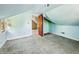 Attic bedroom featuring slanted ceilings, wall to wall carpeting, and a door to another room at 621 N Livingston Ave, Indianapolis, IN 46222