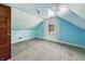 Attic bedroom featuring slanted ceilings, wall to wall carpeting, and natural light at 621 N Livingston Ave, Indianapolis, IN 46222