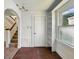 Sunlit entry area featuring stairs with a wood handrail and a built-in bookshelf at 621 N Livingston Ave, Indianapolis, IN 46222