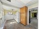 Traditional kitchen featuring updated appliances, tile floors, and convenient pantry storage at 621 N Livingston Ave, Indianapolis, IN 46222
