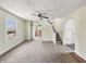 Spacious living room with stairs to the second floor, featuring a view of the kitchen at 621 N Livingston Ave, Indianapolis, IN 46222