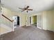 Open living room with staircase featuring an arched doorway to another room at 621 N Livingston Ave, Indianapolis, IN 46222