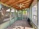 Enclosed patio featuring a ceiling fan, concrete flooring, and views of the backyard at 621 N Livingston Ave, Indianapolis, IN 46222