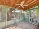 Charming screened-in porch with wood ceiling and fan, offering a relaxing outdoor space at 621 N Livingston Ave, Indianapolis, IN 46222