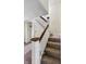 Stairway with carpeted steps and white railings with wood trim at 621 N Livingston Ave, Indianapolis, IN 46222