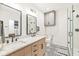 Bright bathroom with double vanity, walk-in shower, and designer tile at 630 N College Ave # 204, Indianapolis, IN 46204